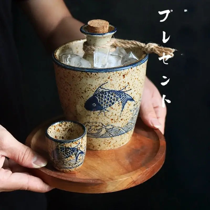 Handcrafted blue fish speckled beige ceramic wine set with matching cup on wooden tray for dining room use