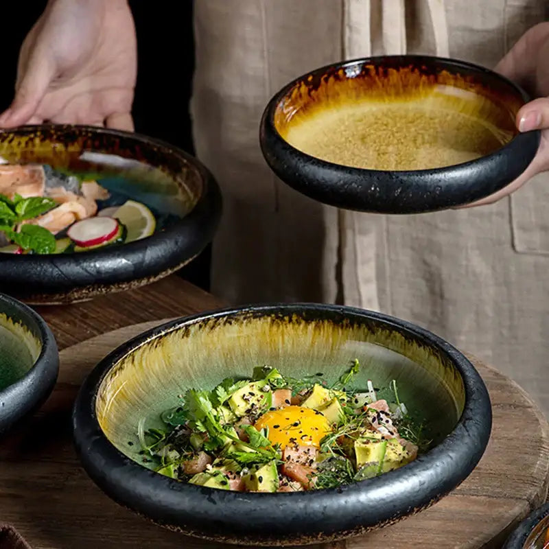 Handcrafted ceramic sushi plate with glossy black rim and gradient amber to green glaze for elegant dining room use