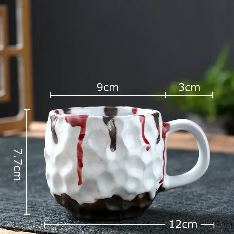 White ceramic hammer pattern ceramic mug with textured hammered surface and red brown decorative drips from ceramic mug set