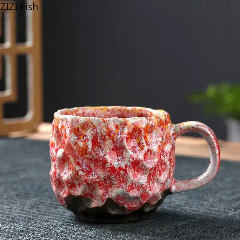 Handcrafted ceramic mug with swirling red and white glaze in a blue and red hammer pattern ceramic mug set