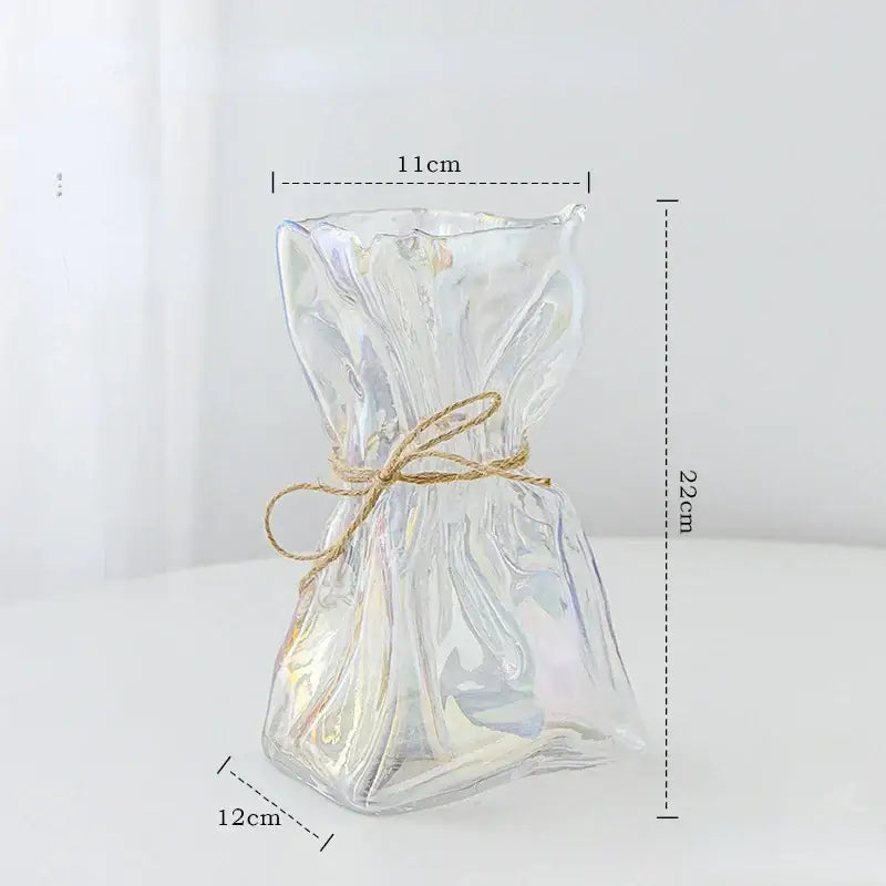 Handcrafted clear glass folded road vase shaped like a tied gift bag with iridescent finish and rustic twine bow for decorbites clear glass decor