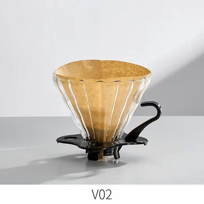 Handcrafted decorbites glass coffee brewer with fluted design, black metal handle, and golden-brown filter paper