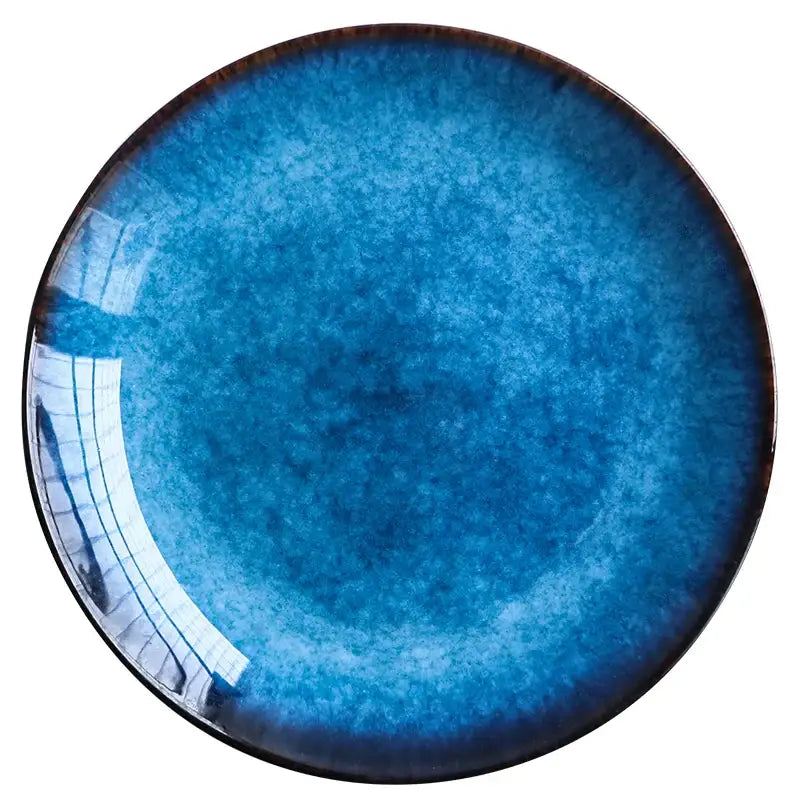 Handcrafted glossy blue ceramic round plate with gradient glaze and dark brown rim in dining room set of 3
