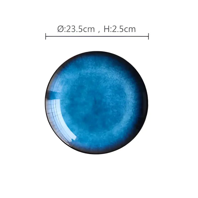 Handcrafted ceramic round plate with gradient blue glaze featuring subtle textures and a glossy finish for dining use