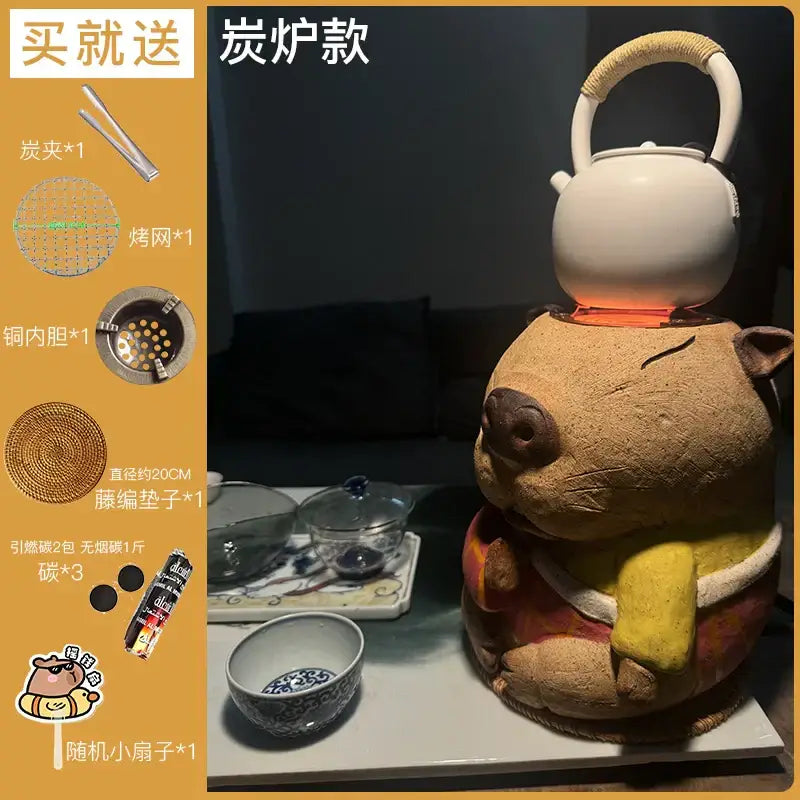 Handmade white ceramic teapot with woven handle on a pig-shaped refractory carbon oven surrounding stove for tea warming