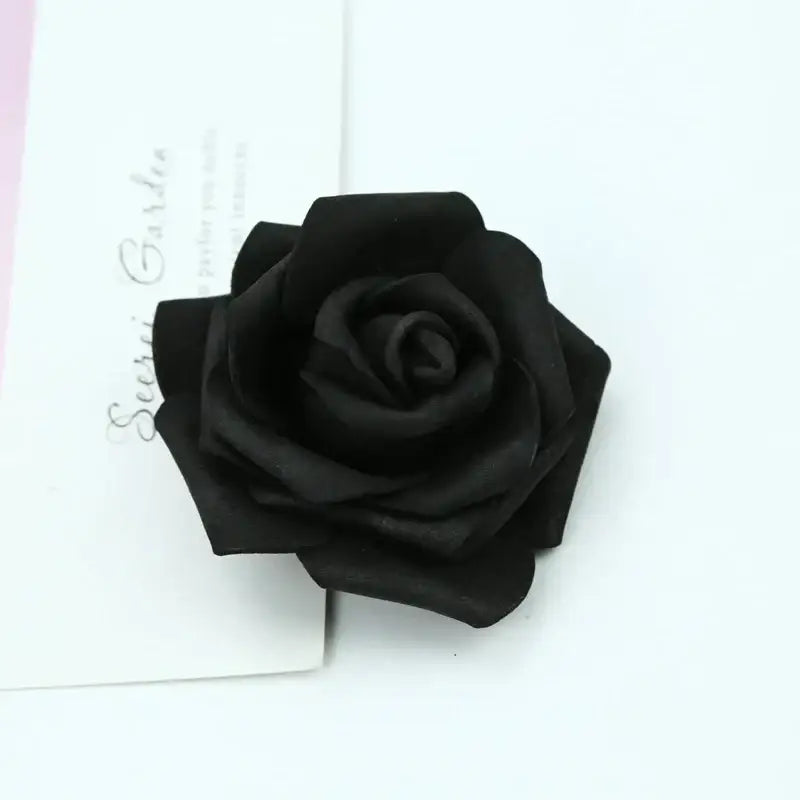 A black handmade foam roses flower brooch with layered petals and glossy finish for decorbites foam roses decor