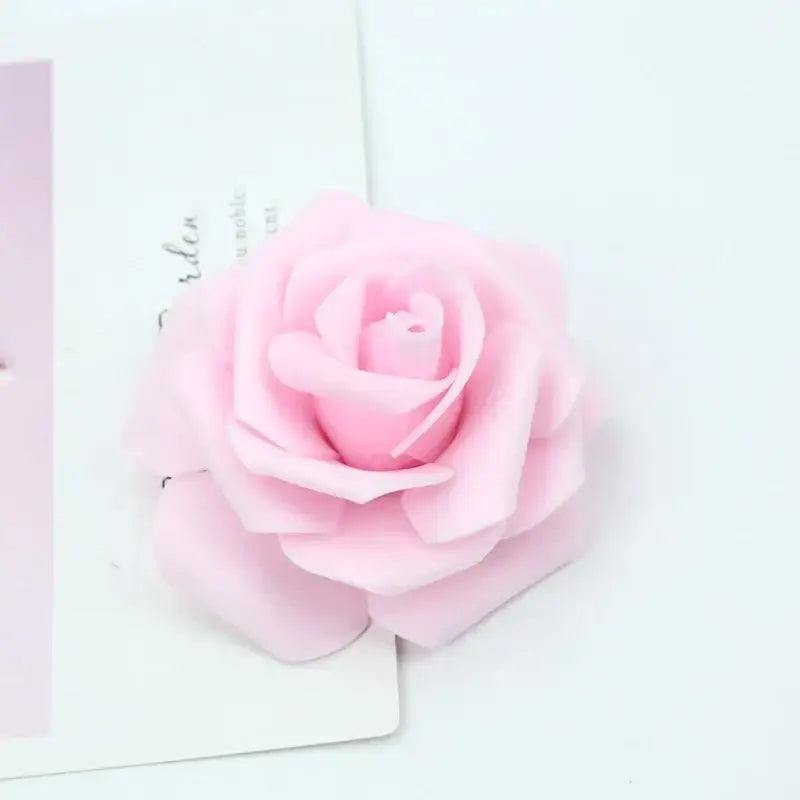 A delicate pink handmade decorbites foam rose with soft layered petals for wedding decor and bedroom bouquet