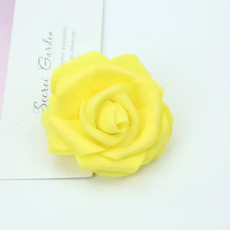 A vibrant yellow handmade decorbites foam rose with soft layered petals for wedding decor and bedroom bouquet