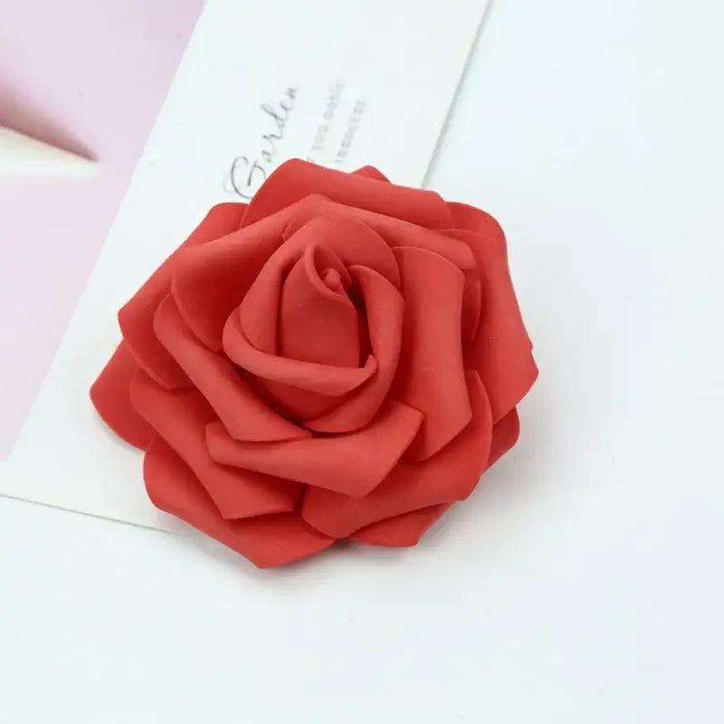 A vibrant red handmade decorbites foam rose brooch with layered petals and soft plush texture for wedding decor