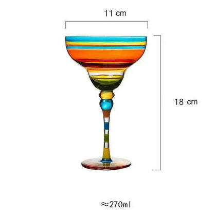 A decorbites handmade colorful margarita-style glass with vibrant orange yellow green and blue stripes for dining room drinkware
