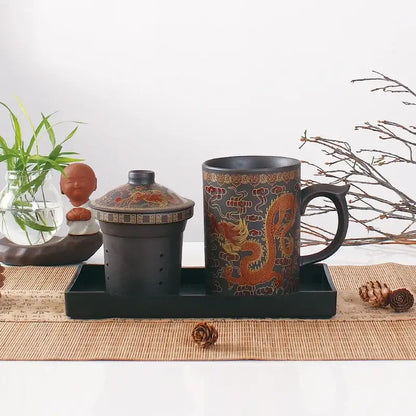 Black ceramic tea mug with intricate orange dragon design made of purple clay from decorbites dragon purple set
