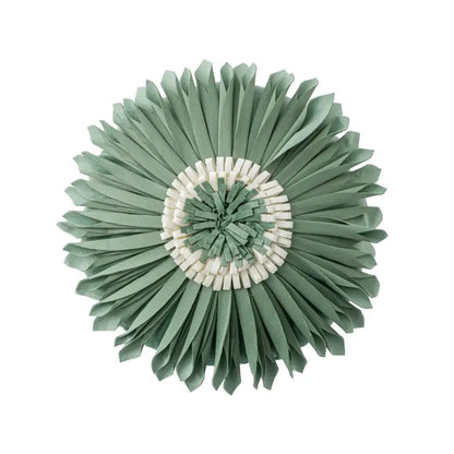 Handmade flower cushion cover featuring a circular sage green and cream paper sunburst wall decorbites handmade flower design