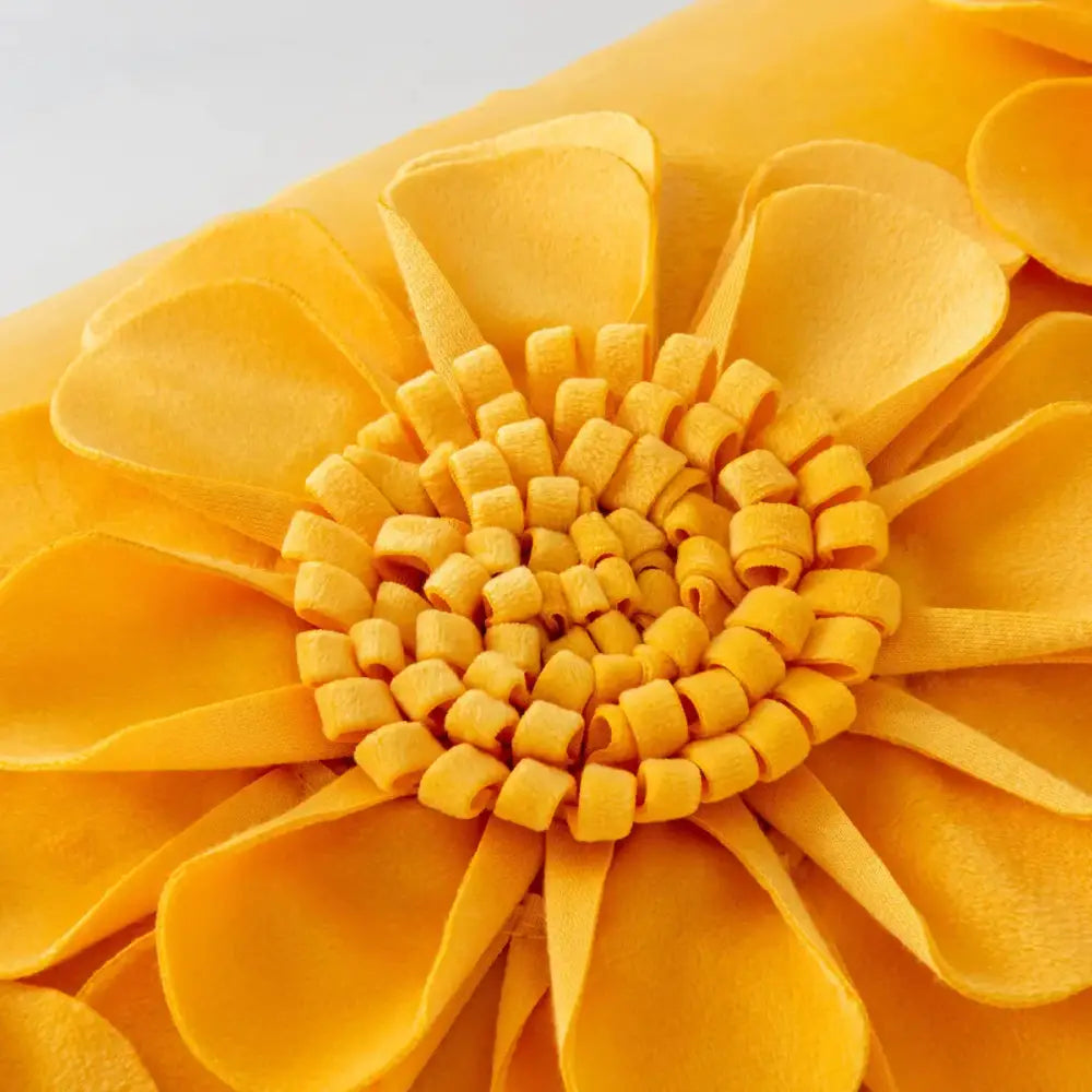 A vibrant yellow felt handmade flower cushion cover with layered petals and a textured center for decorbites handmade flower decor