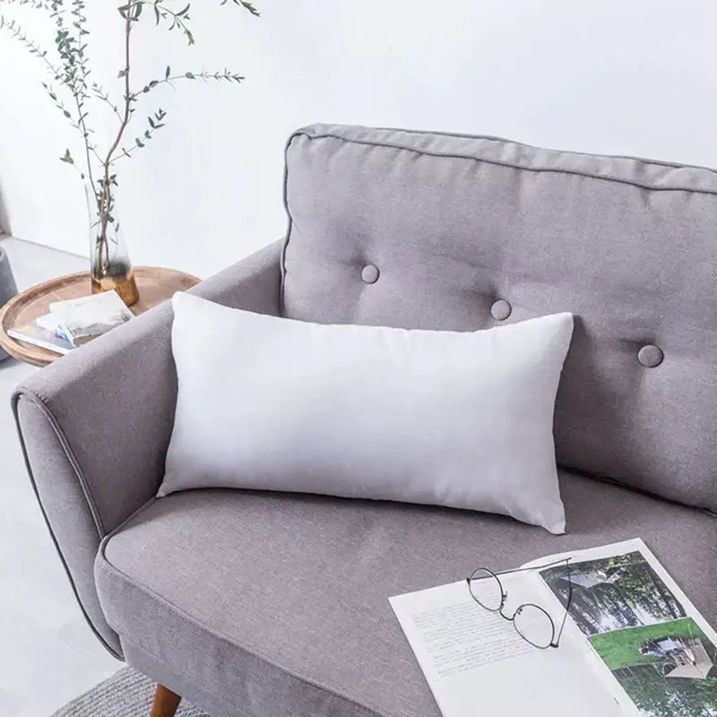 White rectangular handmade flower cushion cover resting on gray sofa in decorbites handmade flower floral pillow set