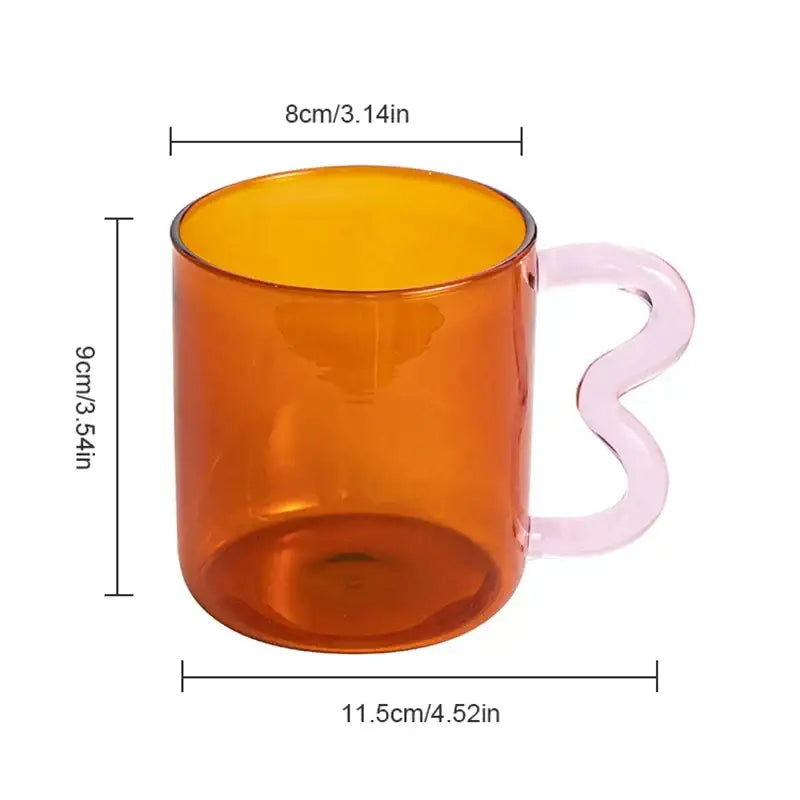 A handmade glass mug amber with a wavy pale pink handle from decorbites handmade glass kitchen collection