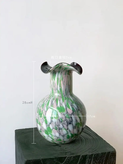 Handmade glass vase with emerald and silver swirling decor featuring a bulbous body and flared black rim by decorbites handmade glass