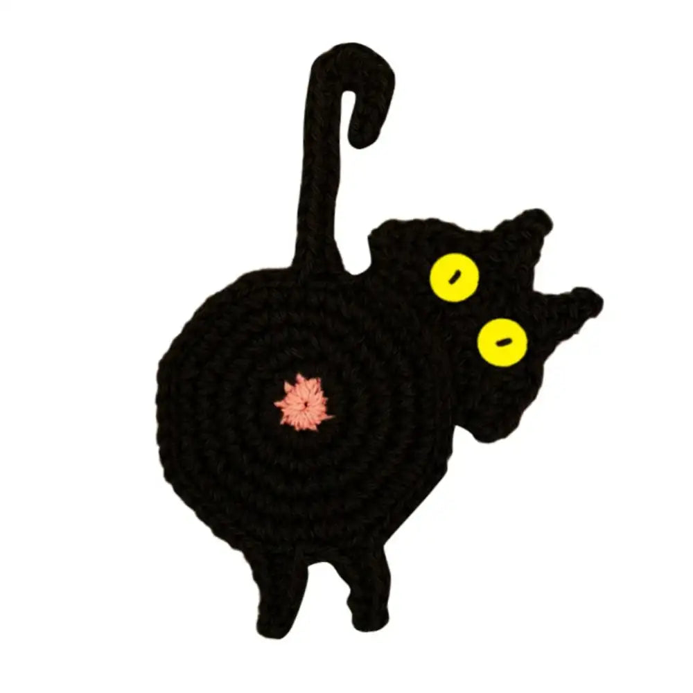 Handmade black crocheted cat butt coaster with bright yellow eyes and pink flower by decorbites cat butt set