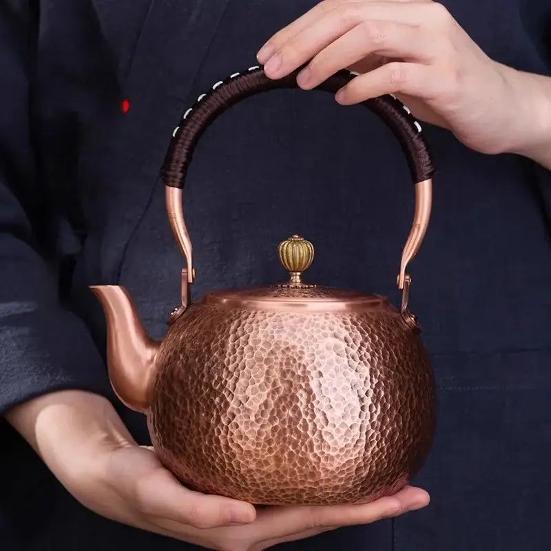 Handmade hammered copper tea pot with dark brown knitting handle wrapped in brass and ornate golden knob decorbites handmade copper