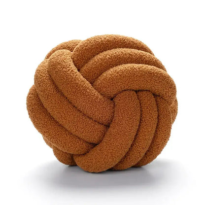 Handmade caramel-colored knotted boucle circle plush pillow with a soft textured surface for bedroom decor