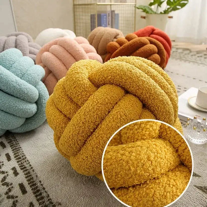 Handmade knotted boucle circle plush pillow in mustard yellow fleece fabric for cozy bedroom decor