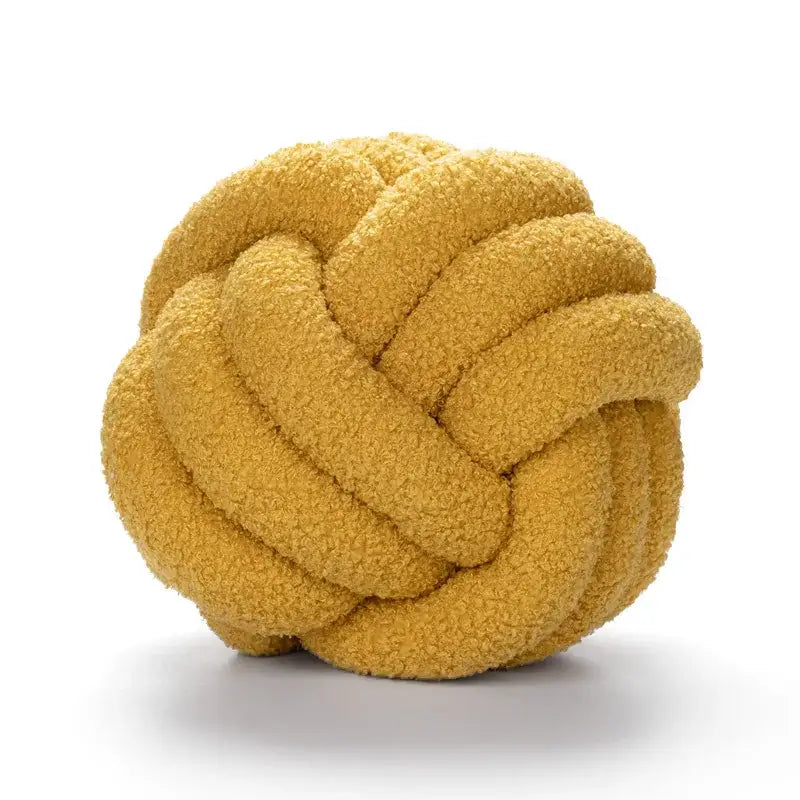 A plush mustard-yellow handmade knotted boucle circle pillow with soft textured fabric for bedroom decor
