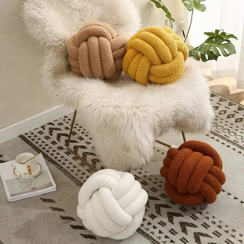 Handmade knotted boucle circle plush pillows in beige yellow white and rust tones for bedroom decor