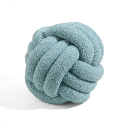 A soft light blue handmade knotted boucle circle plush pillow made of plush fabric for bedroom decor