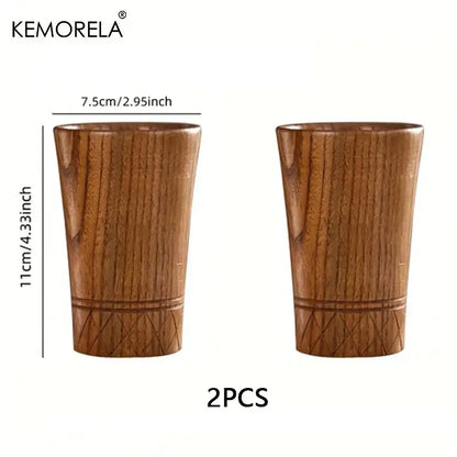Two handmade natural wooden tea tumblers with warm brown finish and subtle engraved diamond patterns by decorbites