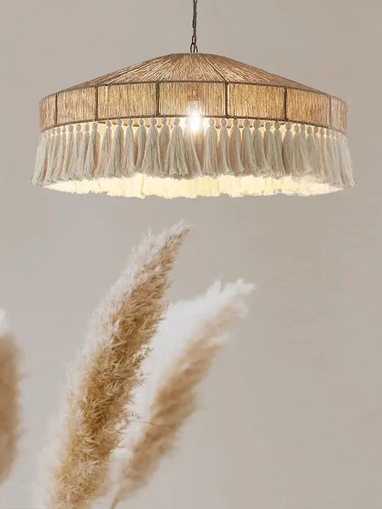Handmade rattan pendant light with warm-toned woven natural fiber shade and cream tassels for dining room decorbites pendant lights