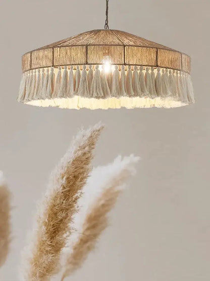 Handmade rattan pendant light with warm-toned woven natural fiber shade and cream tassels for dining room decorbites pendant lights