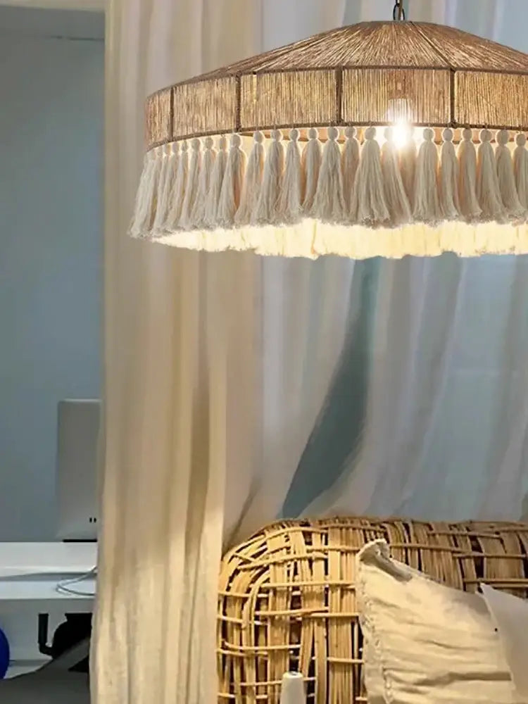 A warm-toned decorbites handmade rattan pendant light with cream tassels for dining room decor lighting