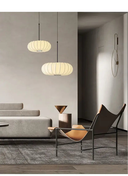 Two cream-colored handmade silk pumpkin pendant lights with ribbed lantern design for dining room decorbites handmade silk