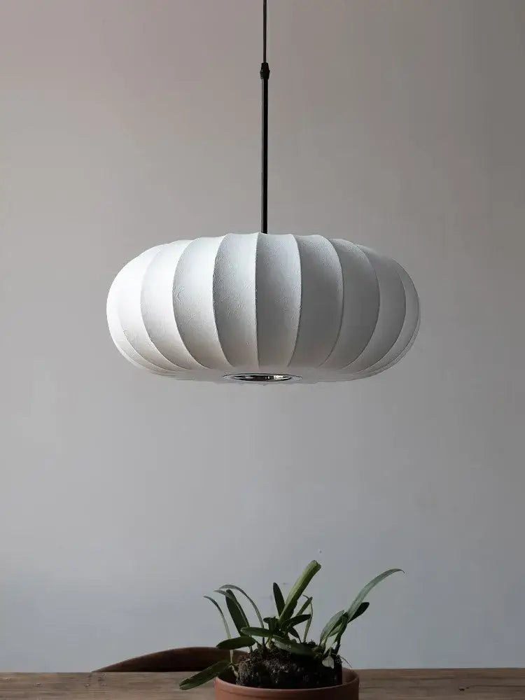 Handmade silk pumpkin pendant light with white ribbed shade and sleek black cord, perfect for dining room decorbites handmade silk