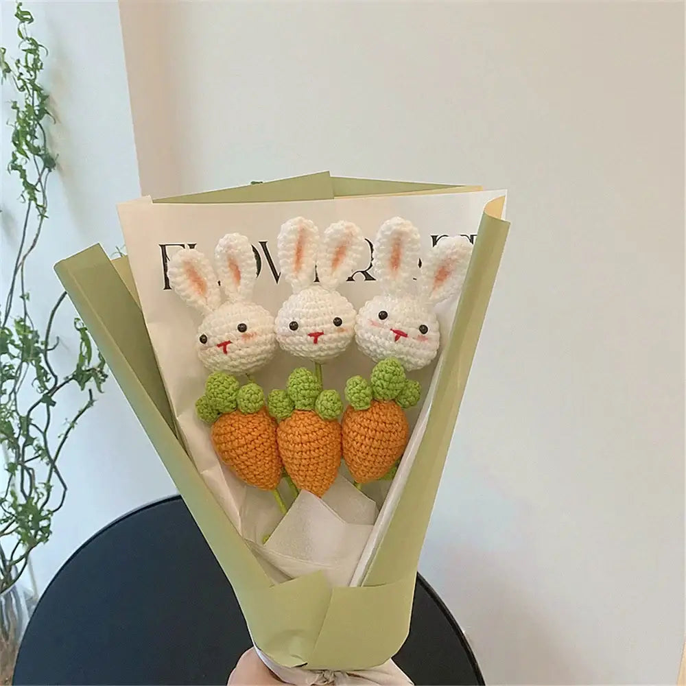 A handmade sunflower bouquet of three white crocheted bunny ornaments each holding an orange carrot decorates a bedroom