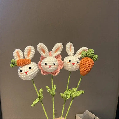 Handmade sunflower bouquet featuring three crocheted bunny ornaments with white faces and orange carrot accessories for decor