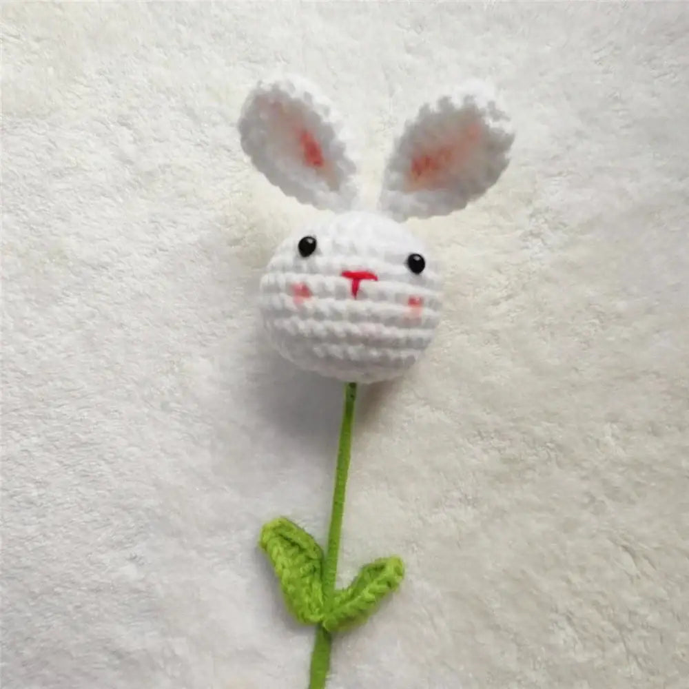 Handmade sunflower bouquet featuring a white crocheted bunny flower with pink ears attached to a green stem and leaves