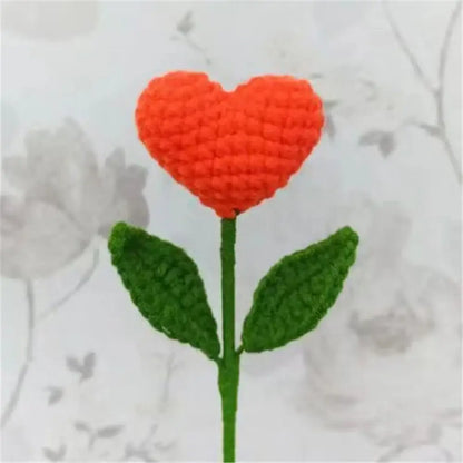 Hand-crocheted orange heart-shaped flower with green leaves in handmade sunflower bouquet crochet bunny bedroom decor