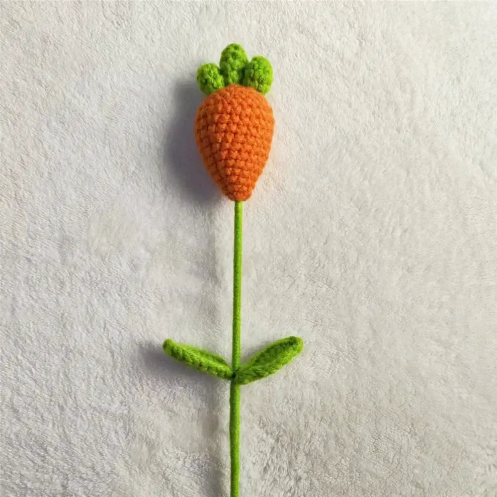 Hand-crocheted orange carrot-shaped flower with green leafy top in handmade sunflower bouquet bedroom decor
