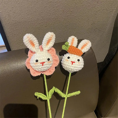 Two handmade sunflower bouquet crochet bunny ornaments with pink petals and an orange carrot for bedroom decor