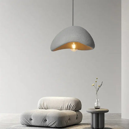 Gray textured half-moon pendant lamp with warm interior glow handmade wabi sabi decorbites dining room lighting