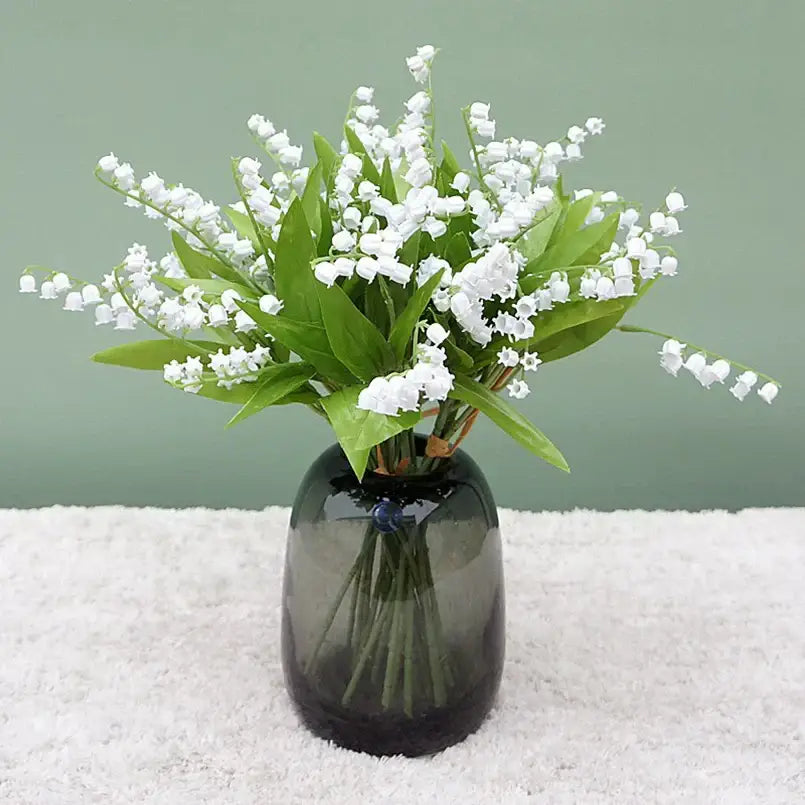 Handmade white bellflower artificial flowers bouquet with delicate lily-of-the-valley and green leaves in a dark vase decorbites bellflower artificial