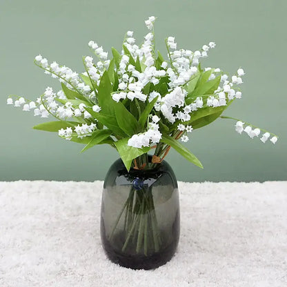 Handmade white bellflower artificial flowers bouquet with delicate lily-of-the-valley and green leaves in a dark vase decorbites bellflower artificial