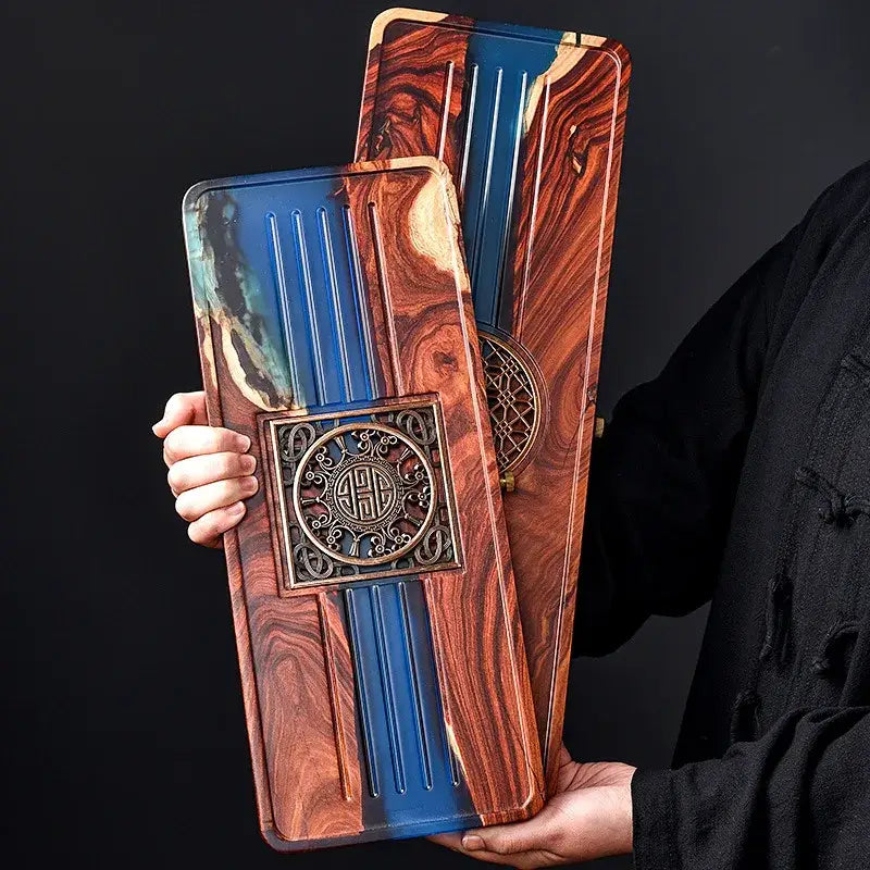 Handmade wooden tea tray with rich reddish-brown grain blue resin inlays and bronze medallion for bubble tea table use