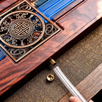 A polished dark wood tea tray with brass inlay and blue glass components for a bubble tea table