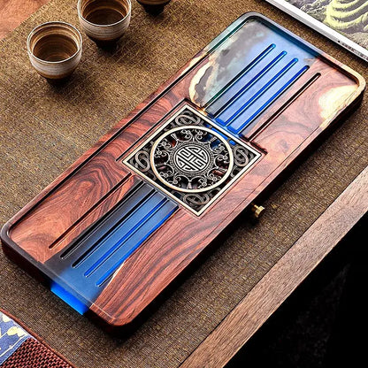 Handmade rectangular wood and blue resin tea tray with glossy reddish-brown grain and ornate medallion for bubble tea table