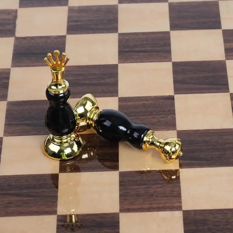 Black and gold glossy chess king piece from handmade wooden chess set for black and white marble games room decor