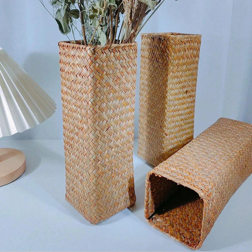 Handmade woven flower vase in natural straw with intricate herringbone patterns in warm beige for home decoration