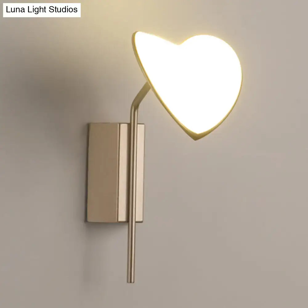Heart leaf gold metal led wall sconce with a brushed metallic base and illuminated heart-shaped diffuser wall light