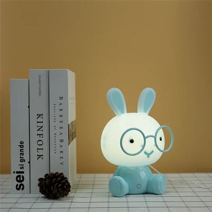 Cute light blue bunny-shaped decorbites cartoon animal night light made of smooth plastic with round glasses and smiling face