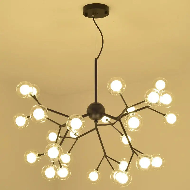 Black metal decorbites heracleum firefly chandelier with gold glass globe bulbs in branching tree-like design for dining room light